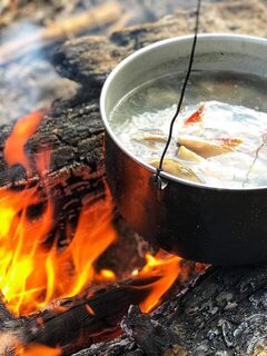 Рыбацкая уха на костре в солнечный день у Кандалакши