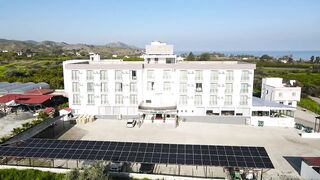 Гюзельюрт районы Северного Кипра спокойная жизнь на холмах цитрусовые сады и бирюзовое море рядом