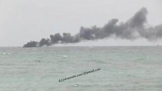 Unawatuna Sri Lanka рыбацкое судно в огне пожар у берега и работа спасателей в море