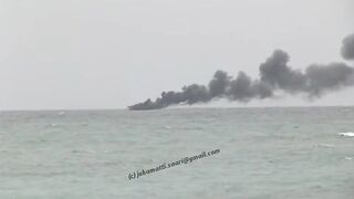 Unawatuna Sri Lanka рыбацкое судно в огне пожар у берега и работа спасателей в море