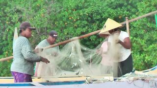 Рыбаки Jimbaran Bali живут и работают прямо на пляже от сети до вечерней рыбалки