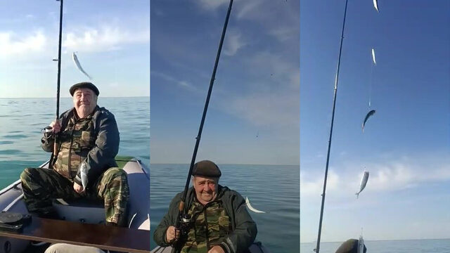 Рыба в руках на моторной лодке у Сочи