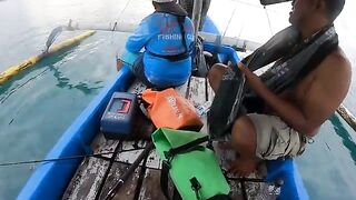 Рыбу на синей лодке у Бали уже держат в руках